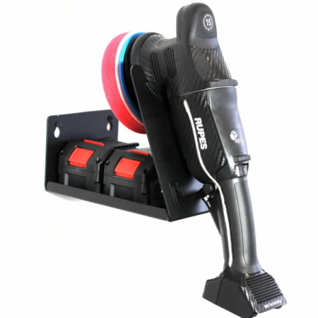 A black machine polisher hangs from a wall-mounted Poka Premium Equipment shelf which has an additional tray for battery storage.