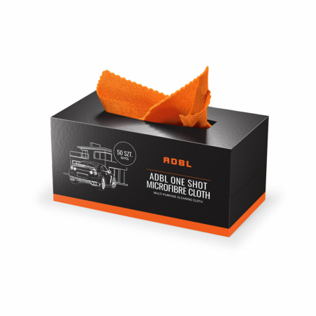 A rectangular black box with an orange trim at the bottom. The black part of the box reads: "ADBL One Shot Microfibre Cloth." An orange microfibre cloth is poking out of the middle of the box at the top.