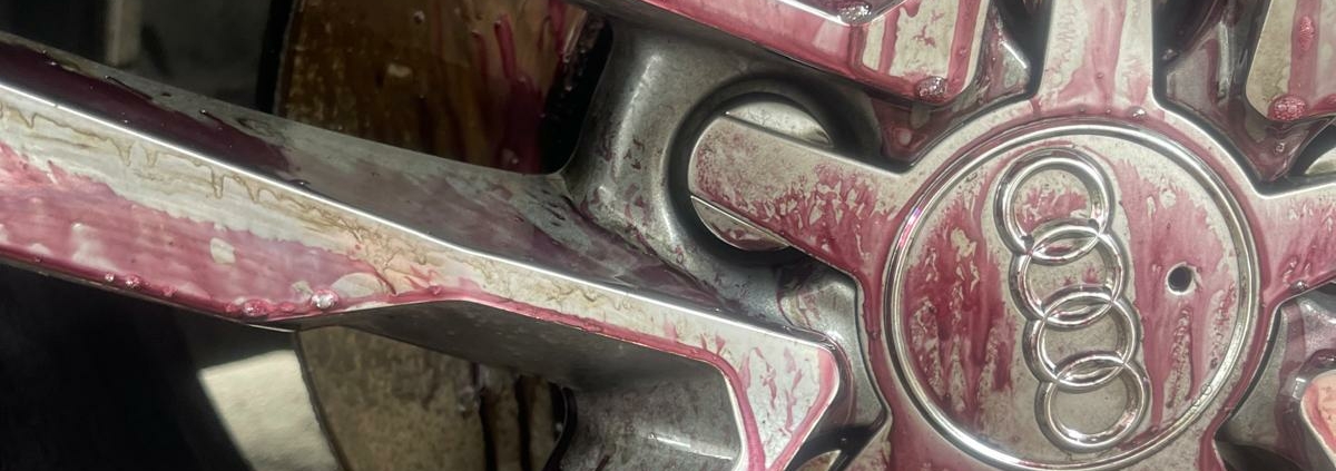 An alloy rim with exposed contaminants (iron fallout).