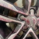 An alloy rim with exposed contaminants (iron fallout).