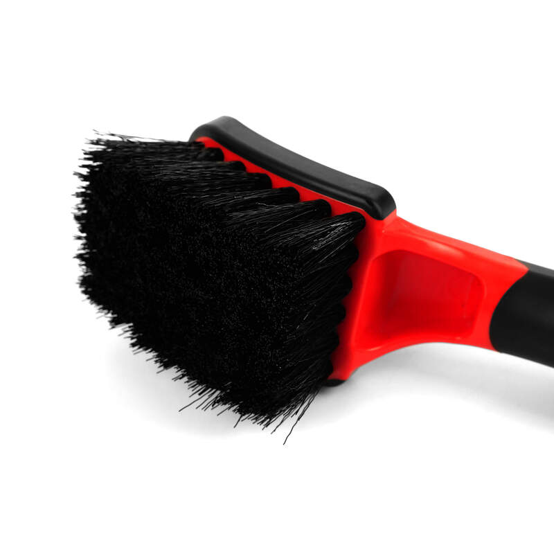 Maxshine Soft Grip Tyre Cleaning Brush - Short Handle Close-up of the Maxshine short-handle tyre cleaning brush showing dense black scrubbing bristles attached to its red and black brush head.