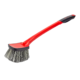 Red Maxshine tyre and wheel cleaning brush with a long angled handle, black rubberised grip and wide head with dense grey-and-black bristles, on a white background.